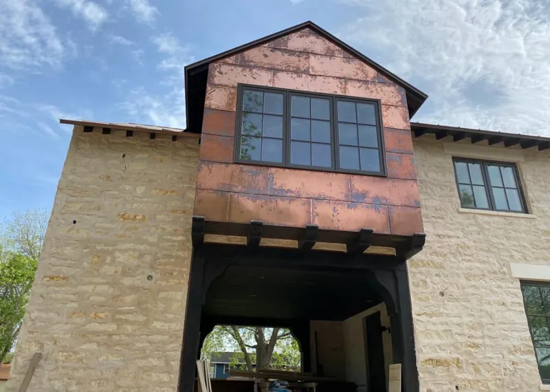 Copper metal panel facade on a stone building for Metal Roof Coating in Lehi